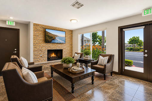 A living room with a fireplace and a painting on the wall.