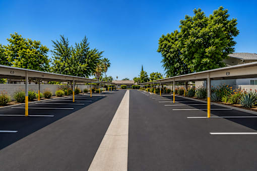 A long parking lot with a clear blue sky above.