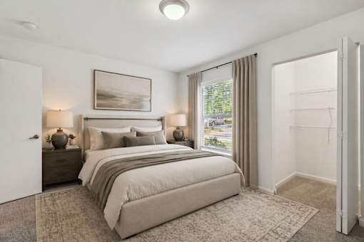A bedroom with a large bed and a painting on the wall.
