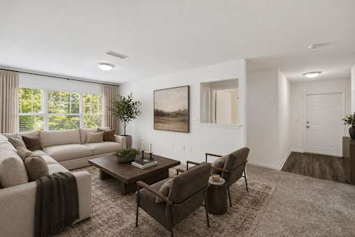 A living room with a large couch, a coffee table, and a painting on the wall.
