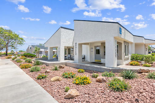 A modern building with a landscaped front yard.