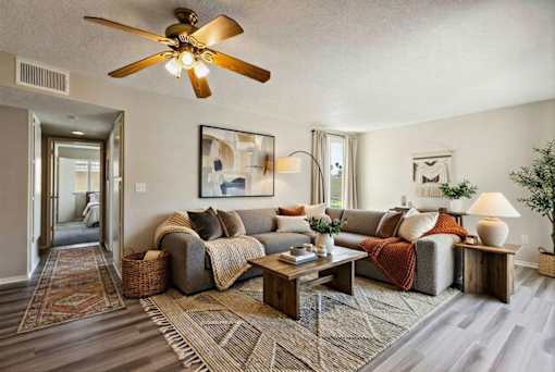 A living room with a grey couch and a wooden coffee table.