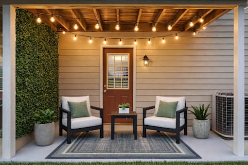 A cozy outdoor seating area with a wooden table and chairs.