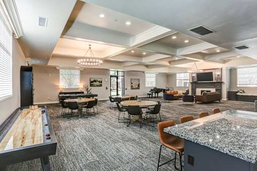 Community clubhouse with game tables and seating areas at The Beckstead Apartments, Utah, 84095