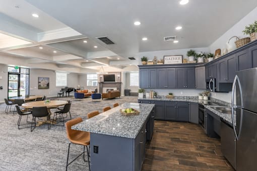 Clubhouse kitchen with granite island and bar seating at The Beckstead Apartments, South Jordan, UT 84095