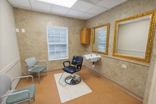 A room with a chair, a table, and a mirror.