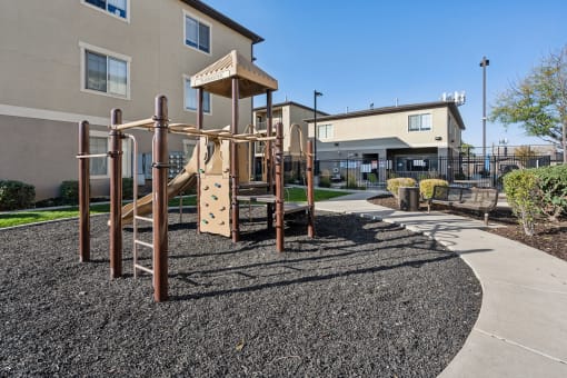 an empty playground in front of a building