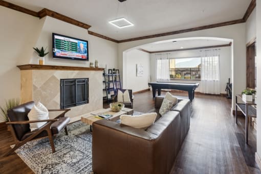 a living room with a leather couch and a television