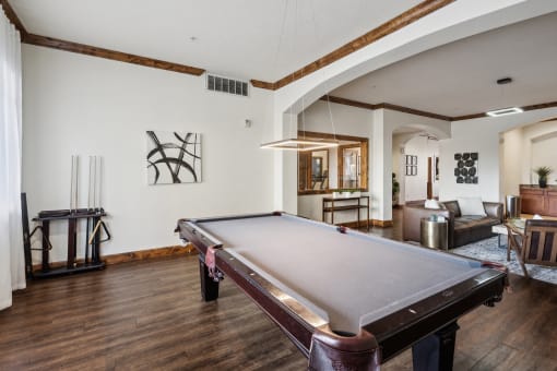 a living room with a pool table in the middle