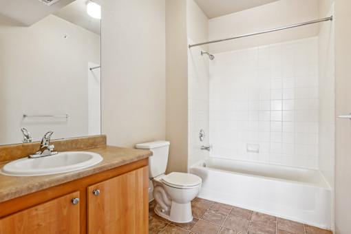 A bathroom with a sink, toilet, and bathtub.