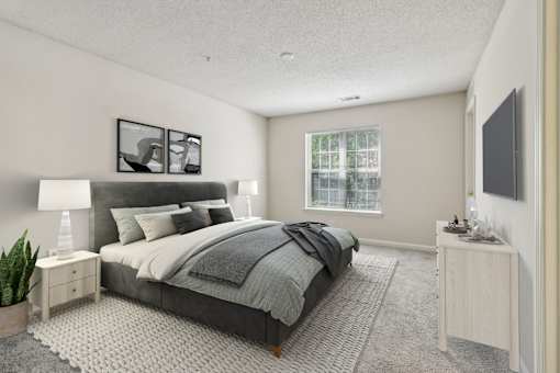 A bedroom with a large bed and a window.
