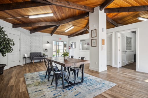 a dining room with a wooden ceiling and a table and chairs