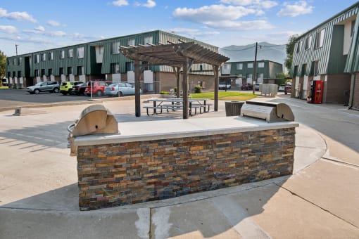 a building with a picnic area and a brick fireplace