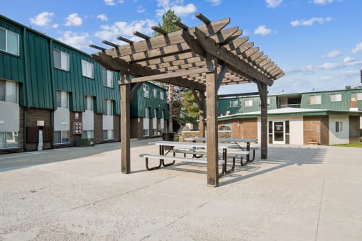 a pavilion with benches in front of a building