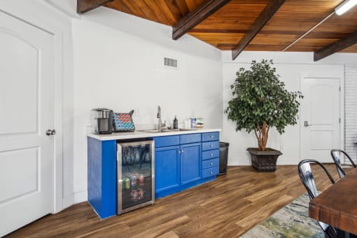 a kitchen with blue cabinets and a table and chairs