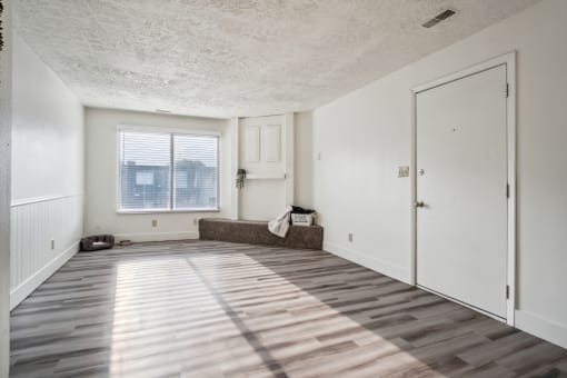 the living room of an apartment with a couch and a door