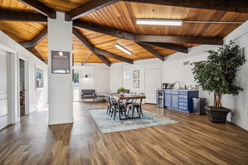 a living room with a wooden ceiling and a dining room table