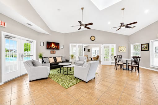 A living room with a pool outside the window.