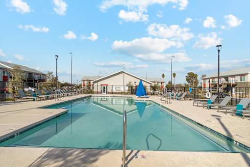 A large outdoor swimming pool with a blue flag in the middle.