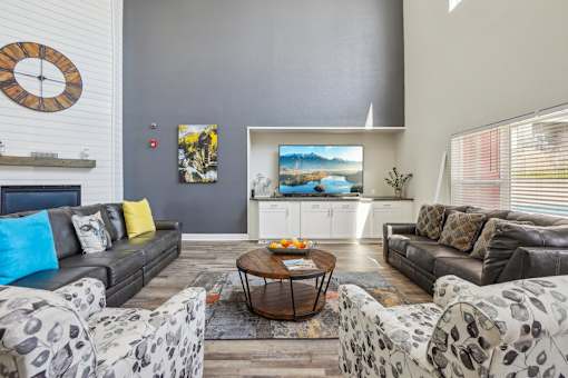 A living room with a grey couch and a coffee table.