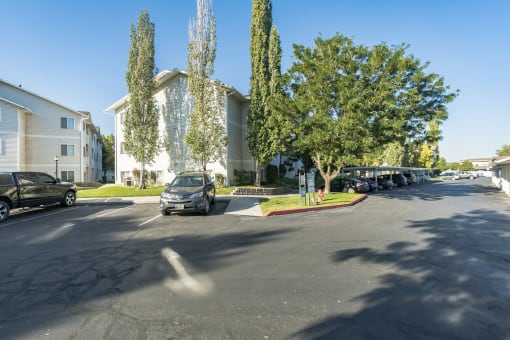 a parking lot with cars parked in front of a building