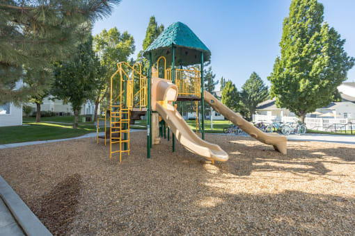 a playground with a slide in a park