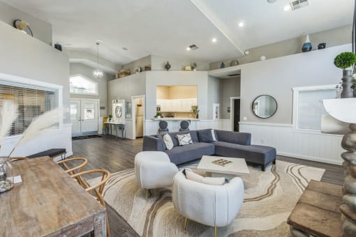 a living room with couches and chairs and a table