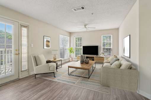 A living room with a couch, chair, and television.