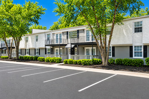 A parking lot in front of apartment buildings.