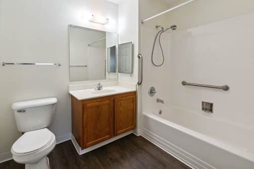 A white toilet sits next to a sink in a bathroom.