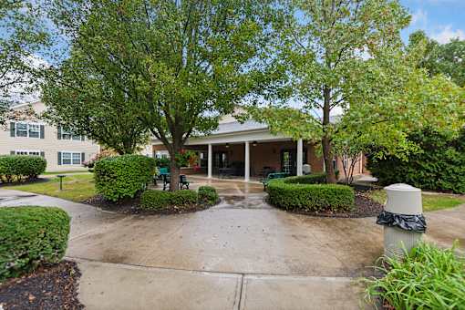A building with a green lawn in front.