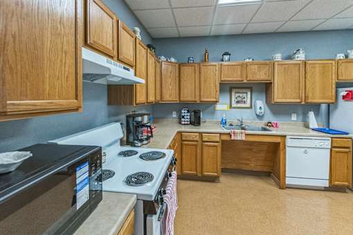 A kitchen with wooden cabinets and a black stove top.