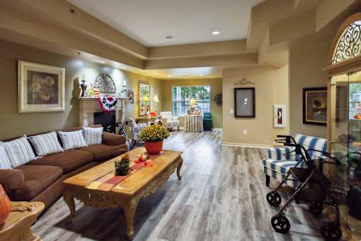 A living room with a brown couch and a wooden coffee table.