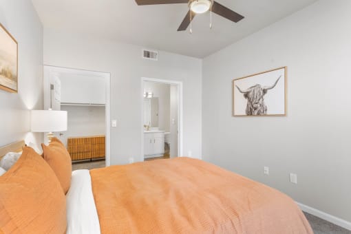 a bedroom with a bed and a ceiling fan