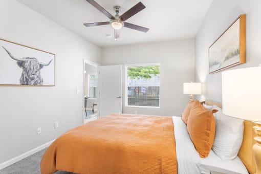 a bedroom with a bed and a ceiling fan
