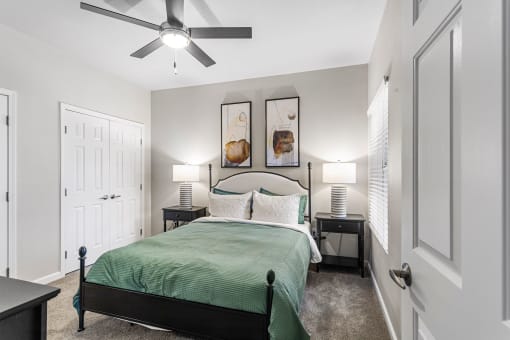a bedroom with a bed and a ceiling fan