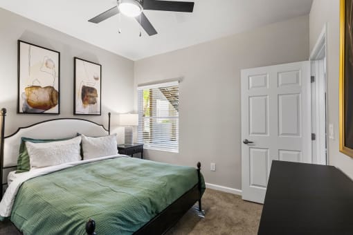 a bedroom with a bed and a ceiling fan