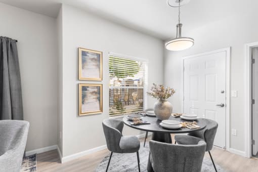 a dining room with a table and chairs