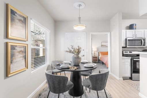 a dining room with a table and chairs
