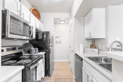 a kitchen with stainless steel appliances and white cabinets