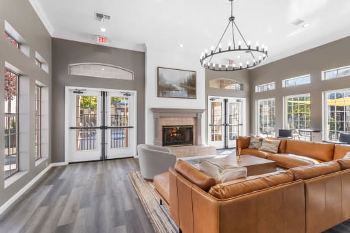 a living room with leather couches and a fireplace