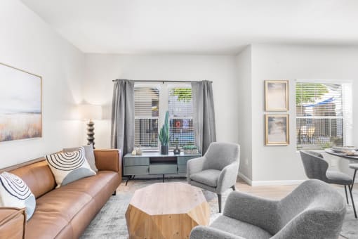 a living room with a couch and two chairs