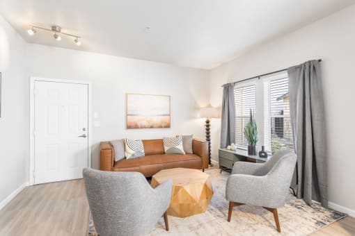 a living room with a couch and two chairs