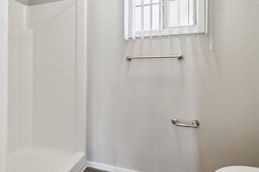 a bathroom with a window and a shower and a toilet at Vista Linda, Santa Fe, NM