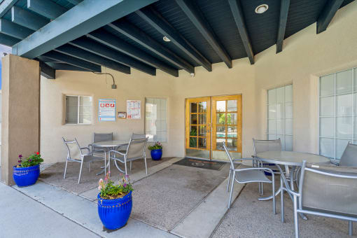 a patio with tables and chairs outside of a building at Vista Linda, Santa Fe