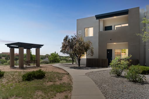 a house with a walkway and a gazebo in front of it at Vista Linda, Santa Fe, NM