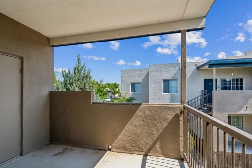 a balcony with a view of a building and a blue sky at Vista Linda, Santa Fe, NM 87507