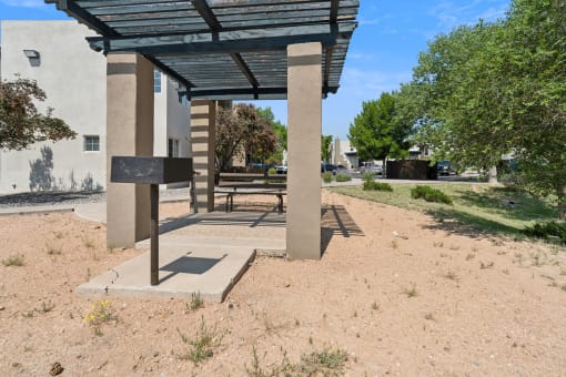 a picnic pavilion with a bench in front of a building at Vista Linda, Santa Fe, New Mexico