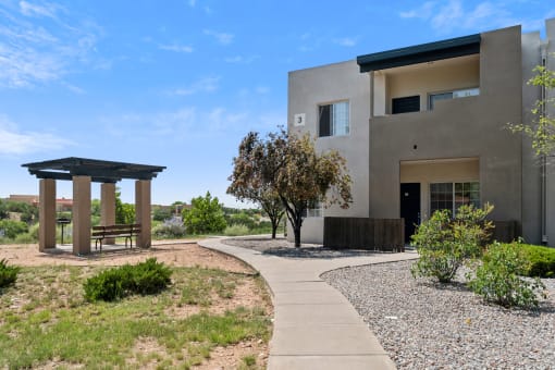 a house with a walkway and a bench in front of it at Vista Linda, New Mexico