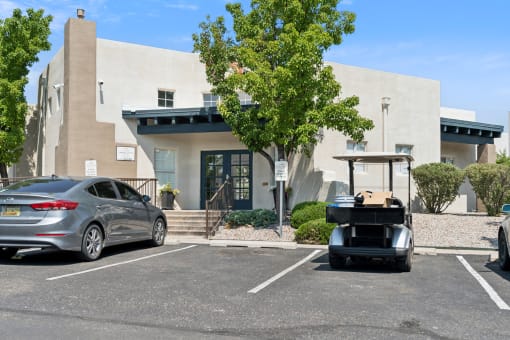 a golf cart parked in a parking lot in front of a building at Vista Linda, Santa Fe, 87507